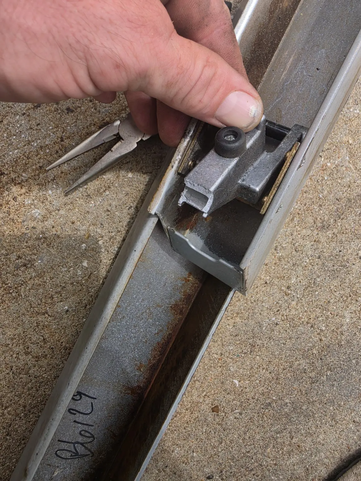 Door latch mechanism being adjusted